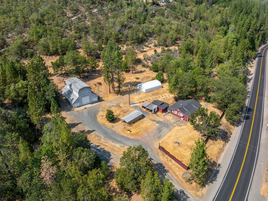 Fantastic opportunity on a beautiful Rogue River property. HUGE 2,200SF barn/shop with dedicated electric and water. Home is comfortable with an updated kitchen, new roof, heat and air and very private. Fully fenced with locking entry gate at the driveway. Conveniently located just a few minutes from the i5 freeway and downtown Rogue River. Enjoy quiet, serene evenings watching the wildlife stroll by. Separate garage/feed stall and small green house are in good shape! Separate electrical meters for barn and home. Excellent location for home business.