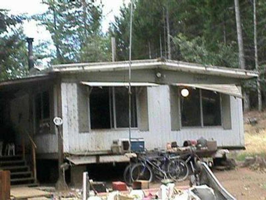 Property Is Surveyed & All Fenced, A Variety Of Trees & Garden Area. Double-wide Needs Tlc. Use Your Imagination On This Interesting Property. Room Sizes Aprox. Selling as Is & Price Will Be Increased When Property Is Cleaned Up. Agent Can Add More