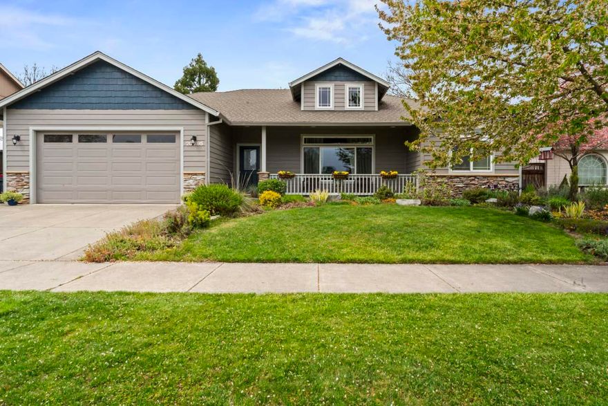 Welcome Home! Enjoy coffee on the covered front porch as time slows down in this lovely 1638 s/f well appointed 3 bed 2 bath home in desirable Hampton Place. 9ft coffered ceilings, hardwood floors throughout, spacious rooms and fully fenced backyard complete with garden beds, mature trees and low maintenance lawn. Dynamite kitchen with plentiful storage, natural gas range and granite slab counters. Dining area opens to kitchen with easy access to large fenced back yard--perfect for BBQs, entertaining & enjoying the beautiful scenery. Master bedroom retreat has a huge walk-in closet, double vanity & Jacuzzi tub in master bath along with private water closet & walk in shower. This home features many upgraded amenities such as speaker surround system throughout home, interior walls & exterior garage door insulated for sound, extra storage.Close to Rogue X, schools & shopping!  Did we mention the views? This house backs up to a special peaceful view that lends itself to a private setting.