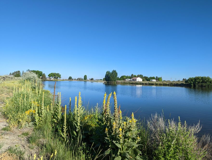 A charming lakeside property. This 14,375-sf. lot lets you fish, kayak, and paddleboard right from your own backyard. Evenings offer beautiful high desert sunsets and star gazing. Land is cleared, fenced and gated offering front and lakeside access. Gravel path constructed on lakeside. Great for potential investment, recreational purposes or build a home. The general aviation airport is just over a mile away. Within walking distance are shopping, credit union, restaurants, laundry, library, EMT services and hardware stores. Enjoy golfing? We have that too with a view of the golf course just across the lake. Opportunities for children are a blocks walk with a playground, picnic tables, splash pad, tennis court, basketball and pickleball. Community events held in the park include a 4th of July celebration, with fireworks that rival Portland.