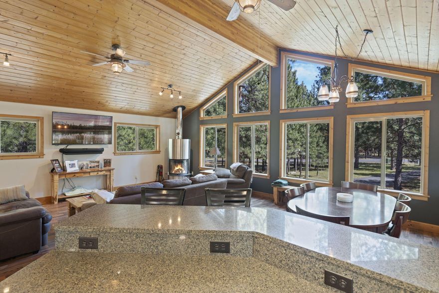 Sitting on a perfectly maintained 1.15-acre corner lot accented with mature Ponderosa Pines, this beautiful home offers flexible living and newly updated features. Primary bedroom, bathroom and guest bathroom recently remodeled with stunning modern finishes such as radiant floors, tile steam shower, beautiful tile floors, smart LED vanity mirror and soaking tub. The light and bright kitchen featuring granite countertops flows seamlessly into the lodge style great room showcasing warm wood finishes and a beautiful, one-of-a-kind Scandinavian stainless steel wood burning fireplace. Downstairs offers a separate 1200 square foot additional living space which has its own private exterior entrance. It features 2 primary bedrooms each with their own bathroom, living room, separate laundry and kitchen area. A perfect mother-in-law, college student, traveling nurse opportunity or just more space for you. Located 1.5 miles from the highly rated Sisters schools and beautiful downtown Sisters, OR