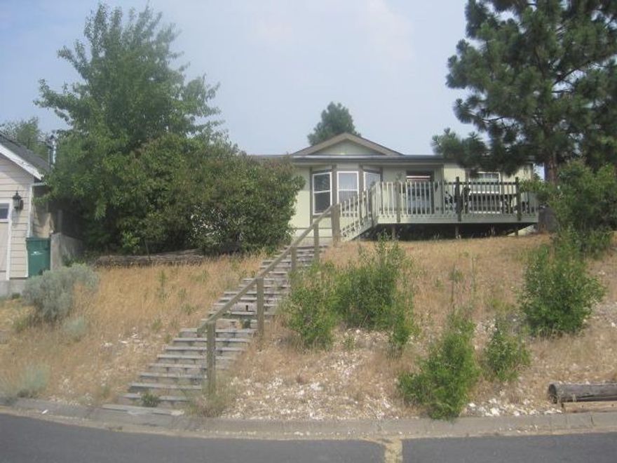 Double wide manufactured home with views.Large deck on the front and a fenced yard in the back. 320 sq ft work shop with a 200 sq ft loft. Sold As Is.