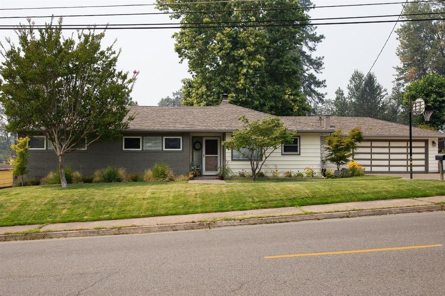 Lovely mid-century NE Grants Pass home on a hard-to-find, third of an acre lot, with all kinds of upgrades. Gleaming wood floors with over-sized windows to let in all the light, heated tile floor in the kitchen and gorgeous granite counters. You'll love the formal dining room and wood-burning fireplace. There's 1606 square feet with three bedrooms and a bath and a half, all heated by natural gas. And oh, the backyard...with a deck surrounding a hot tub, there's lots of lawn for critters and kids shaded by an enormous sycamore tree, plus a huge fenced garden with raised beds.