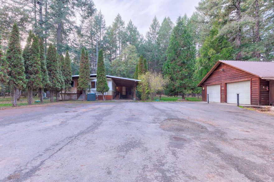 New Price! Back on the Market! This incredible 4.89 flat-acreage gem offers the perfect blend of opportunity and comfort. Nestled on this expansive lot is a 2-bedroom, 2-bathroom manufactured home, includes a large utility with storage, and additional secure storage room off the back of the home. Over-sized detached 2 car garage with workspace, and a whole house Generator. The property's flat and usable terrain opens the door to a world of possibilities, making it an ideal canvas for those with a green thumb, a passion for farming or to live in comfort and quiet surroundings. The grounds are fenced and gated, ensuring both privacy and security. Don't miss out on this fantastic opportunity - schedule a viewing today!