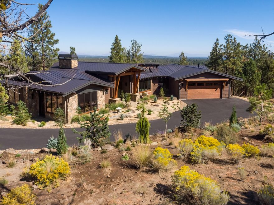 Stunning NW Contemporary home, recently completed by Norman Building & Design, is located in the gated North Rim community. Thoughtfully designed to bring the outside in, the single level home features vaulted ceilings & an abundance of windows. Mt Jefferson is framed by the great room windows; panoramic views include Smith Rocks & Powell Buttes. The high quality selections & attention to detail will delight you! Montana mossy custom fireplace, Humbarton lighting fixtures, white oak flooring, wood framed windows, extensive use of Sepele wood. The open, spacious kitchen features custom Anigre cabinets, Sandalus quartzite on the island counter, Ceasarstone, Wolf & Subzero appliances. Great separation between the primary suite & office, and the guest suites/den. Covered & uncovered decks with fire-pit & heaters. Oversized 2 car garage with dog wash, cabinets & more! Landscaped, treed, 1 acre corner lot is a peaceful retreat, while the location is close to trails, the river & downtown Bend