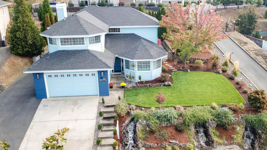 This lovely home has been beautifully updated and remodeled complete with new wood floors, porcelain tile floors in the kitchen, along with stainless appliances and quartz countertops. Walking through the front door you are greeted with a gorgeous staircase leading to 4 bedrooms and 2 full bathrooms. The view of the city from the five windows in the master bedroom is spectacular and provides the most stunning sunsets. The is plenty of storage throughout the home. Downstairs you will find a spacious laundry room connecting to the 2 car garage as well as a private office, powder room, and large cozy family room with gas fireplace. The kitchen offers a breakfast nook and a large peninsula looking into the spacious dining room and living room. The low maint. backyard provides privacy while the front yard is nothing short of a show piece complete with 3 custom waterfalls. This home has a brand new composition roof (2018) new paint (2018) and parking for your RV.  Come see for yourself