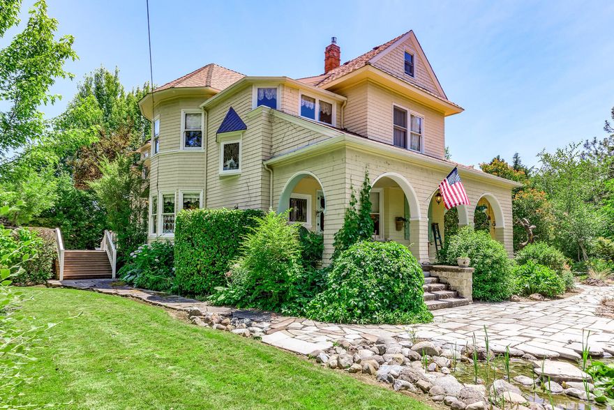 Stunning 1905 built Hill House is tucked away on an estate sized 1.18 acre lot in an area of SW Medford w/ many grand homes. Behind the privacy hedge the long drive, framed by mature trees & lush landscaping, leads to this beautiful vintage home. The park-like yard has a small pond & stream w/ butterflies & dragonflies, a large trex deck, & numerous other hidden areas; a real oasis!  
The fabulous front porch invites you into the home, w/ a large formal LR, a dining rm that opens to the family rm, & a stunning kitchen that includes a huge island & a butler's pantry, centered around an AGA stove & custom mantle. A large laundry rm is located off the kitchen. Upstairs are 3 large bedrms, an office, & 2 baths. The master has a luxurious spa bath w/ a separate tub & walk in shower &  walk in closet. The office is charming w/ storage areas & a bath. The home includes walls of windows, built ins, high ceilings, & hardwood flrs. It also has a 2-car & 780 sf RV garage, & a carriage house.