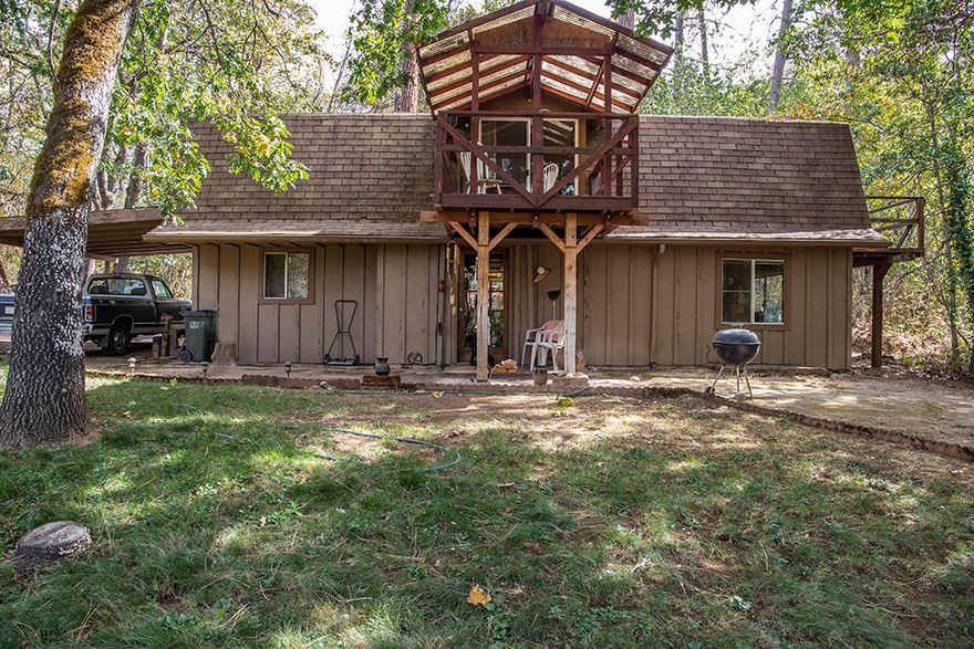 New Roof & Gutters. Septic pumped & inspected, new electrical panel & Hot water heater. Private wooded 1.42 acres w/ board & bat barn-style house (gambrel roof); 2 story, 2 bed, 2 bath home w/ 2 decks, patio & large picture windows overlooking seasonal Owl creek. Country cabin in the woods feel. Front lawn & garden area, flat use able & private. Large turn-around/RV parking or room for toys, attached carport. 12 gpm well (per well log).  Open beam tongue & groove wood ceiling in living room & kitchen, tile floors. Woodstove & baseboard heat. Window A/C. Soaker tub w/ dbl vanity bath downstairs & shower only ¾ bath upstairs. Convenient built-ins & workspaces/W/D step up for ease. Both bedrooms are upstairs w/ vaulted open beam ceilings & split layout, separated by a ''den'' w/ glass slider to deck. Master upstairs w/ private deck. Strictly shown by Appointment only -No Drive-by. Home sets back off the road. Newer drain-field, septic will have been pumped & inspected, well tested too.