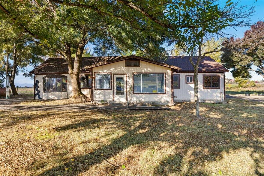 Welcome to your slice of country living in beautiful Eagle Point! This 8.75-acre property offers
irrigation rights, flat usable pasture, and stunning mountain views—all just minutes from town. The two bedroom, one and a half bath home is ready for your vision. Remodel the existing home or build your dream home in
this peaceful setting. Enjoy a gated driveway, barn, and shop, well and septic system already in
place. Whether you're looking for space for animals, gardening, or a quiet retreat with room to grow,
this property has endless potential. Property to be sold as-is, cash only, no owner carry.