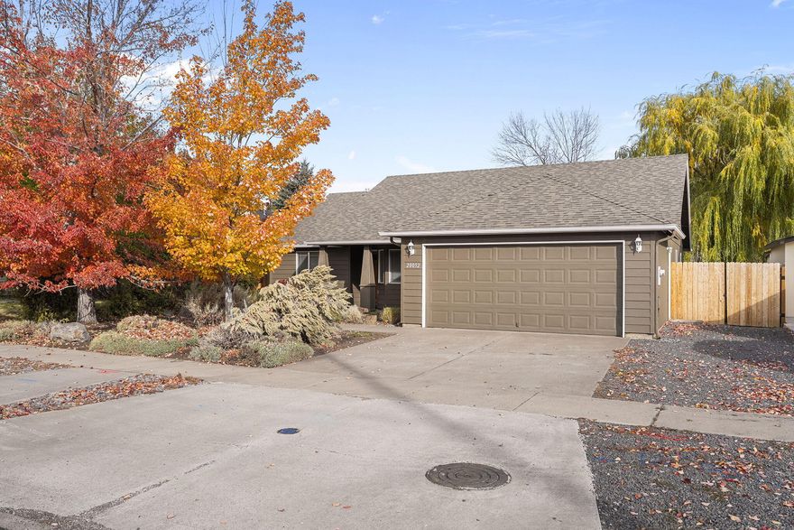 Welcome home to this charming single-level, 3-bedroom, 2-bath home located less than 2 miles from the Old Mill and under 1 mile from the Deschutes River Trail. Enjoy Bend's best outdoor lifestyle with the convenience of town nearby. Thoughtful updates include a new hot tub, exterior paint, stainless steel appliances, HVAC system, fencing, and updated flooring in the primary bath. Offering a $4,000 credit toward new flooring so you can add your personal touch. Features include vaulted ceilings, a cozy gas fireplace, low-maintenance front landscaping, mature trees, and side RV parking with a 2-car garage. The spacious primary suite offers an ensuite bath, and the home is sold fully furnished—ready for you to move right in and start living the Bend life. Call for your private showing today!