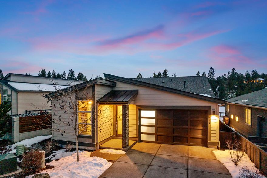 Explore this single-level gem in the Pointe at River's Edge, nestled between Deschutes River & The River's Edge Golf Course. A premium lot ensures added privacy, featuring an open floor plan w/ modern finishes & 8' doors throughout. The vaulted great room, bathed in natural light, boasts a floor-to-ceiling mantle, & golf course views. The kitchen showcases a Quartz island, oversized breakfast bar, quality appliances, & engineered hardwood floors. The primary suite offers golf course vistas, double vanity, tile shower, & a spacious closet. An additional ensuite perfect for guests & additional 3rd bedroom w/ Murphy bed. Enjoy summer evenings on the paver patio w/ golf course and peek-a-boo river views. A 2-car garage with epoxy flooring & built-in storage accommodates your toys. Smart home features add modern convenience. Benefit from private River Trail access 1 mile to shops, & Downtown Bend. A perfect blend of elegance and functionality awaits in this beautiful home.