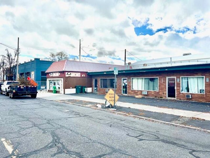 Busy downtown location across from the Post Office. 2,160 sq ft commercial building with 3 possible units, 3 bathrooms, and 3 separate entrances. Ample on-street parking plus ~6 off-street spaces. Newer roof. Currently leased to a single tenant who occupies the entire building. Flexible layout offers potential for multi-tenant income, or owner-occupier with rental income. High visibility, easy customer access, and strong downtown traffic.