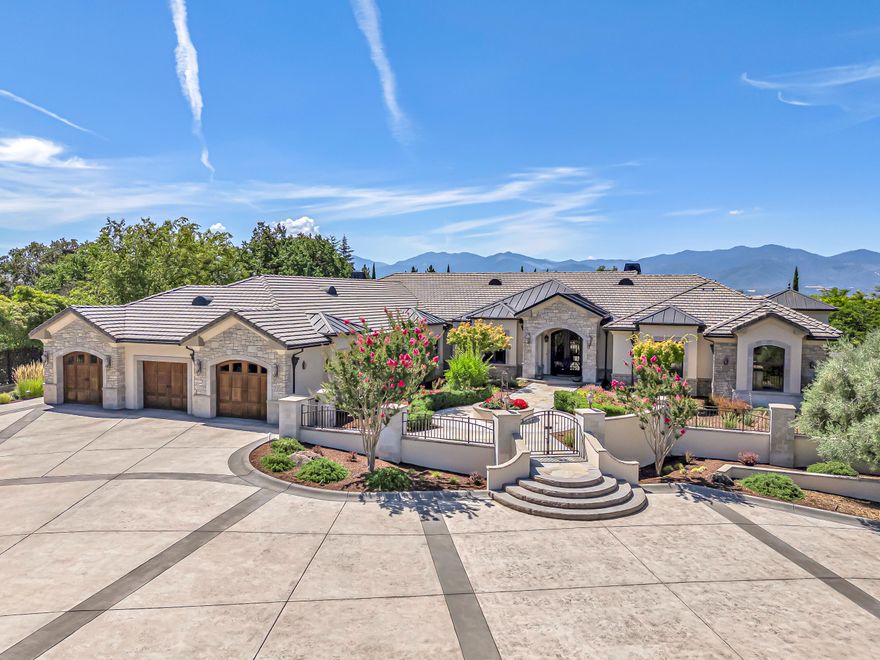 Enter across the threshold of this luxurious estate's grand custom iron and glass doors into a realm of refined class and sophistication. The entrance exemplifies the masterful design, boasting luminous windows with stunning valley views, gorgeous walnut flooring, one-of-a-kind ceiling art, and outstanding light fixtures that create a truly majestic ambiance of elegance and warmth with each room you enter. From the large spectacular gourmet kitchen with magnificent custom detail to the large lush outdoor living space perfect for entertaining, this gorgeous home is sure to captivate and impress the most discerning luxury buyer.