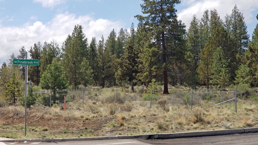 Positioned on the south side of Bend (west of 97, kitty-corner from Walmart), this lot is: 1) ideally located for a multi-unit housing project or retirement/care facility, 2) has maximum exposure, 3) is very accessible, 4) is nearly level & 5) has native tree cover. This lot to be sold As-Is; buyer to do their own due diligence. The seller is a real estate broker licensed in the State of Oregon.