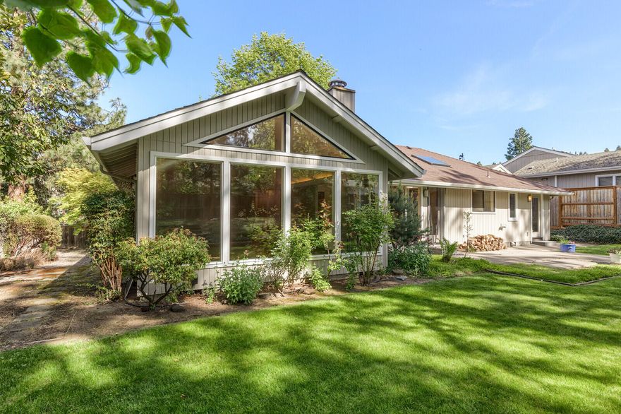 Light and bright contemporary 2 bedroom, 2 bath single level home on a large .24 ac lot. This comfortable home offers an open floor plan ideal for entertaining. The living room is one of the highlights of this wonderful home. It boasts vaulted ceilings and a wall of windows that floods the space with natural light and a view of the private and peaceful backyard, lovely gardens and mature trees. Retreat to the spacious primary bedroom with updated bath and access to private garden area. The large second bedroom can be split into two rooms to create another bedroom or office. Two car garage with lots of built-in storage. Room for ADU (check with City of Ashland for details). Seller has building plans for the ADU which can be made available with an accepted offer. All of this plus easy access to the trail network, SOU Market of Choice and the conveniences of Ashland.