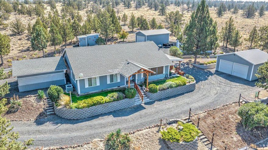 Incredibly laid out property with beautiful home with many amazing spaces for outdoor entertaining. This home has been immaculately cared for and masterfully landscaped with double car garage, RV garage, large workshop, additional RV covered area with full hookup, and additional covered carport. The home has vaulted ceilings in living room, sliding doors onto covered BBQ patio and covered deck that is perfect for watching the beautiful sunsets over the Cascade Mountains. There is an outdoor fire pit with outdoor bar area that is perfect for family gatherings. There are even horseshoe pits, a garden area and plenty of room for family games and activities. Property is located next to BLM on the south and there are 2 additional parcels available.