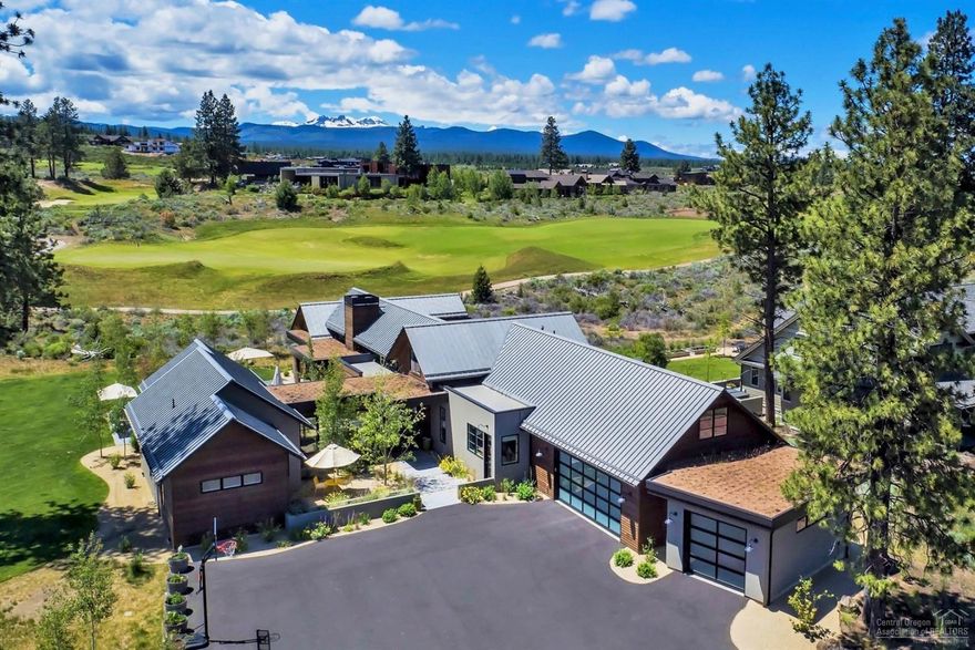Crisp white walls & reclaimed wood provide both clean lines & warmth in this beautiful modern estate in the heart of Tetherow. A great room is centered on an indoor/outdoor fireplace w/ windows & glass doors transforming the home into an indoor/outdoor sanctuary. Custom build offers 4 spacious bedrooms, 4.5 baths & large office all on ground level. Like the rest of the home, the kitchen & dining strike a perfect harmony between modern touches & warmth. Enjoy quartz counters, stainless appliances & a large butler's pantry & island. On the 2nd level find an add'l bonus room over the garage w/ wet bar, skylight & views of the 12th fairway. For those holiday overflow times, find the custom ladder to a loft area overlooking the course. Nestled between the 11th, 12th & 16th holes, this home offers an unmatched sense of privacy. With a beautiful front courtyard, back patio w/ stone fireplace & a fully landscaped yard, this space ties you to the great outdoor living that Bend has to offer.