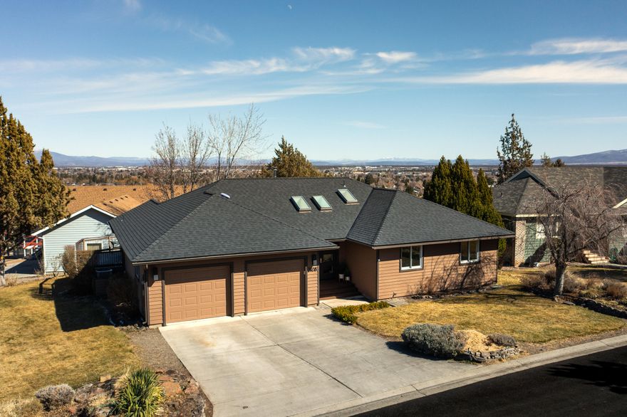 This 2,626 sq ft recently updated home, located on a corner lot in SW Redmond, features single level living with a 400 sq ft daylight basement with separate entrance. The open floor plan lives large, vaulted ceilings with large skylights in great room provide plenty of natural light. The kitchen includes granite tile counter tops with breakfast bar and nook. Large dining area with deck for viewing beautiful Mountain View's. Private office area. The oversized primary bedroom has a separate private deck that is hot tub ready with additional mountains views, walk in closet, powder room and jetted tub. Minutes away from everything that Redmond has to offer.