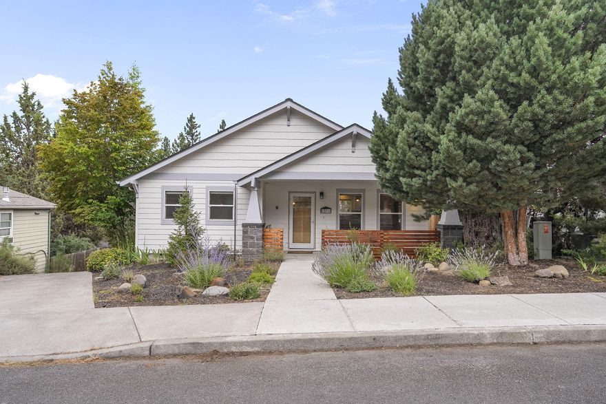 Beautifully updated and full of light, this 3 bed, 3 bath home in Westside Pines is just a short walk to Newport Ave's shops, restaurants, and groceries—plus minutes to downtown Bend, Shevlin Park, and the Galveston/14th corridor. The remodeled kitchen features Bellmont cabinets, quartz counters, and new appliances. Fresh flooring flows through the main and lower levels. An Xtrordinair 854TV fireplace efficiently heats the 1,808 sq ft home. The vaulted-ceiling primary suite includes a reading nook, walk-in closet, and a tiled bath with jetted tub. A finished basement with a full bath offers flex space for guests, a home office, or a media room. Updates include a new roof (2021), furnace (2020), interior and exterior paint, and a new deck. Step outside to a beautifully landscaped yard with a new outdoor fireplace—perfect for entertaining. Located in a sought-after neighborhood near COCC with no HOA, near trails, breweries, and all the best of West Bend. Come see it today!