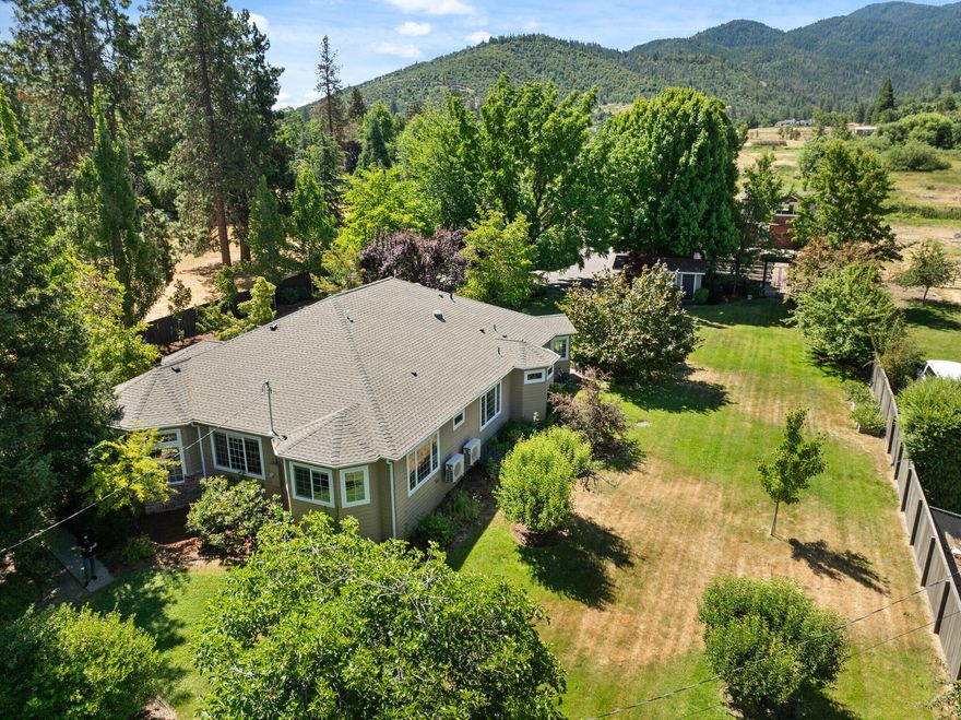 Exquisite estate in serene private rural setting with all the conveniences of being in town on 3.4 irrigated acres with manicured grounds, pasture, and multiple outbuildings. The single-level, 3014 sf home features 3 bedrooms + study, and 3 baths with gorgeous mosaic tile. The spacious kitchen boasts leathered granite, antique glass-front cabinets, center island, gas range, and large pantry. Enjoy hardwood floors throughout, gas fireplace, & energy-efficient Mitsubishi mini-split system. The elegant primary suite offers a sitting area, walk-in closet, and courtyard access. Outdoor living includes a pebbled-concrete courtyard with boulder water feature and fire pit, huge fenced-in garden, tons of parking space, and all the outbuildings you could need: finished barn with bathroom, studio garden workshop, storage building, detached 2-car garage with carport + office space, plus a magical tree house! Complete with gated paved entry, TID irrigation pond, RV parking. Eligible for ADU.