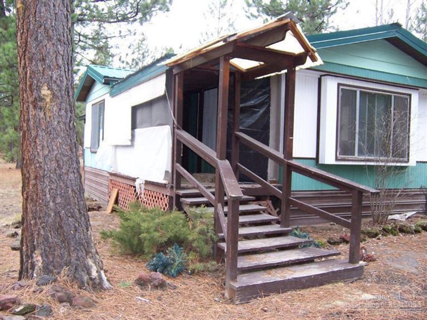 1977 14x66 2 bedroom with 1 1/2 baths. This is a fixer, Buyer may need to upgrade on septic system. Septic tank has not been pumped. Seller is selling in as is condition and doing NO repairs. Buyer to do his or her own due-diligence on this property. No kitchen appliances included. Front and Rear covered deck. Well. Some fencing.