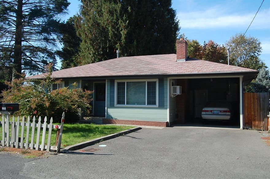 Adorable cottage style home located close to the Rogue River and Park, and downtown Grants Pass. Great home for someone looking to scale down and yet loves to garden. White picket fence in the front and backyard fenced for privacy. Covered deck off the back of the home looks out over the spacious back yard...lots of gardening potential and a large garden shed for storage. Roomy living room is accented by a brick fireplace. Fabulous vintage style kitchen with wainscoting on the back wall and wainscoting look on the cupboard doors. The kitchen features a garden window and skylight. This really cute home is a must see.