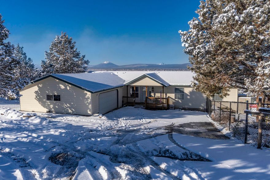 A ROOM WITH A VIEW! Yes, a Cascade Panorama from all living spaces! Viewing deck is partially sun-screened, with pergola, off a 1782 sq ft, 3 bedroom, 2 bath home, with large entry, huge master suite with jetted tub, second master, large living room and all appliances included. Kitchen boasts a wood top, rolling island, self-cleaning, propane cook stove, pantry and built-in microwave. The living room is perfectly built to take-in the view, with a full wall of tall windows and you will also enjoy the free-standing propane stove on a cold winter's night. The oversize garage houses 2-cars and a host of cabinetry and shop tools. Enjoy your fenced English garden with waterfalls & pond, all spring and summer, from the paver patio or the benches along the garden path! Heating/Cooling system, carpet, water heater and Stainless, French-door refrigerator have all been updated! Driveway is asphalt and utility services are underground! Better hurry!  It won't be around for long!