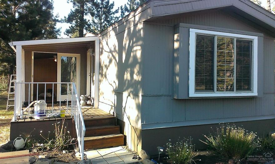 If you want a clean entry level home or a vacation home this should be on your list. 2 bedrooms a sunroom and office/bedroom adds extra room. This home is close to Sunriver has river access with a private boat ramp and dock. On .50 of an acre build your dream home or add a shop. All utilities are installed with community water and sewer so no hassle with a septic. Nice new homes all around make this a great investment.