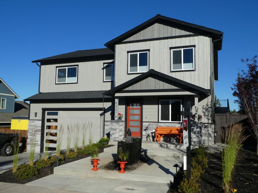 This contemporary reverse-living modern home greets you with a custom-built water & fire feature, and immaculate landscaping. The ground level has 2 BR, one with a slider to the covered patio, a bathroom and a sitting room. The stairs to the main living area are framed by a stone accent wall. Upstairs you will find a modern contemporary kitchen with high-end appliances, granite countertops, modern farmhouse lighting, and a separate workstation/coffee bar. Outside is a delightful patio with views of Pilot Butte. The expansive living space with mountain views offers plenty of room to enjoy conversation, relax, and watch TV. The master bedroom has a wood inlayed tray ceiling. Entering the master bath, you will find a modern chandelier, oversized tile shower, and spacious double vanity sinks. The finished garage has an epoxy floor, separate work area, storage room, custom multi-purpose room, and rear garage door for pull through storage of a boat or trailer. RV parking with hookups.