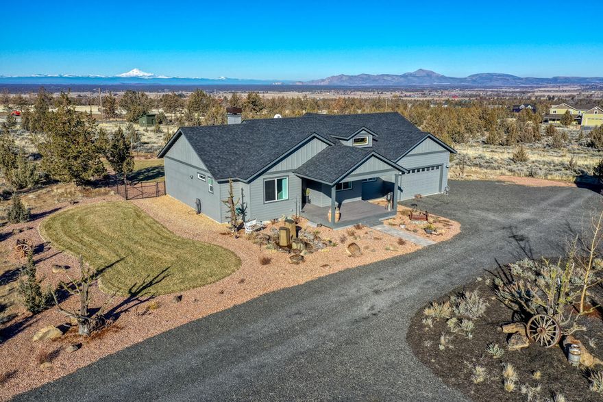 Pristine Cascade Mountain Views on 4.83 acres from this newer construction, builder's own home located in Powell Butte. There is a 26 x 40 fully insulated 3 bay shop with 220 AMP service in addition to a 2 car garage attached to home for a total of 5 covered parking spaces. Plenty of RV parking. Backyard is fenced with professional landscaping.  The heat pump provides heating in the Winter and cooling in the Summer. Wood burning fireplace to keep the family room warm and cozy. House has 3 expansive bedrooms and a den. There is an additional bedroom and bath with a separate entrance off the back deck for guests.