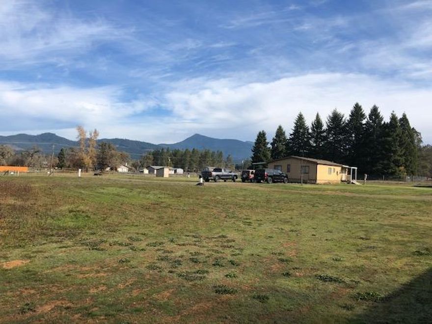 This mini ranch/farm is perfect set up for livestock, nursery or ?? Really nice property with views of mountains surrounding Illinois Valley that is unparalleled. Split bedroom designed dbl wide with front deck capitalizing on mountain views. Pasture is not irrigated, but this is a good area for 1/2 acre vegetable garden. Separate dbl car garage, barn, equipment shed and storage buildings too. This has been used in the past for cannabis cultivation and still has potential grow site.