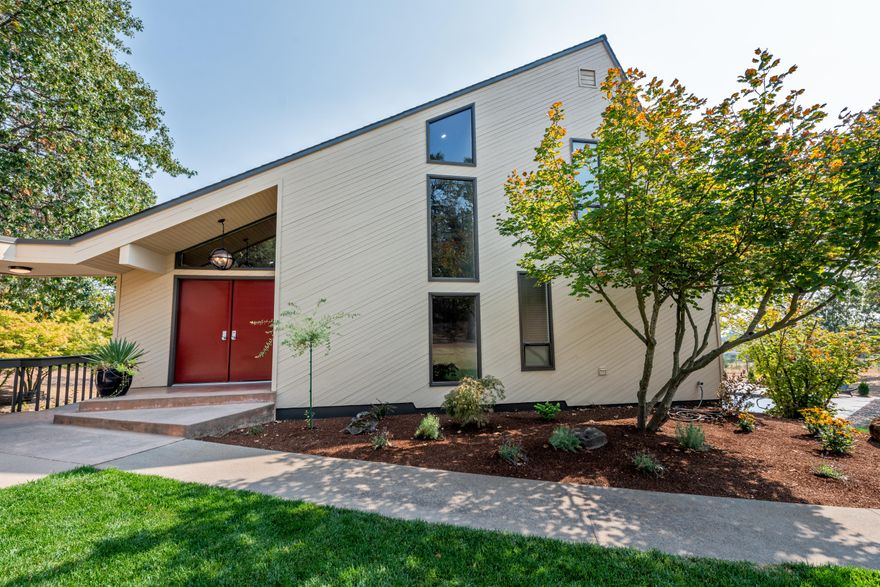 West Hills  w/many newer updates! Privacy & location 5 min to Jacksonville. 2.91 Irrigated acres w/in ground gunite pool, tennis court, pond, lg decking around the home,  mature landscaping. Paved & gated entry, 3 level home offers 4 lg bdrms, + bonus rm. Main level lg vaulted cedar ceilings in great rm & dining rm, solid wood floors, lots of windows & sliders to enjoy the outdoor living. Tiled sun rm, lg bright open kitchen over looking the pool. Kitchen is updated w/quartz counters, island, convection wall oven, stainless steel appls, euro style cabinets & built in desk/office area. Lg laundry rm & built in 2nd desk. Updated baths incl quartz counters, tile floors & shower, dbl sinks in main & master bath. Master suite on the upper level w/soaking tub, lg tile shower w/dlb heads, tile heated floors & walk in closet. Lower level; 3 lg bdrms, utility & bonus rm w/access to the patio & pool. 768 SQFT garage w/workshop area & 20X24 finished rm above garage + separate detached garage/shop