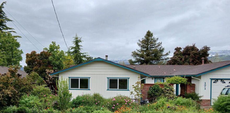 Single story ranch home on .20- acre lot. Two blocks from Helman School & located near the dog park, Ashland pond, Bear Creek & the bike path. Conveniently located within walking distance of downtown, w/ mountain views. In winter, Mt. Ashland can be seen from kitchen. Grizzly Peak is visible from the back of house. Updates include: int. & ext. paint, patio floor paint, two new windows, new roof in '17, kitchen stove hood, switches & outlets, hall tub/shower plumbing upgrade & new toilet. River rock border around house in front garden. Lovely double sized master bedroom, two full bathrooms, living/dining room and spacious family room. Private courtyard out front & large covered patio out back, accessible from the dining room. Attached 2-car garage w/ interior walls to create a small music studio/multipurpose work/craft area. Mature landscaping w/ pollinator friendly garden in front yard. Organic only landscaping: fruit trees, bushes, raised garden beds. Furnace plus wood stove!