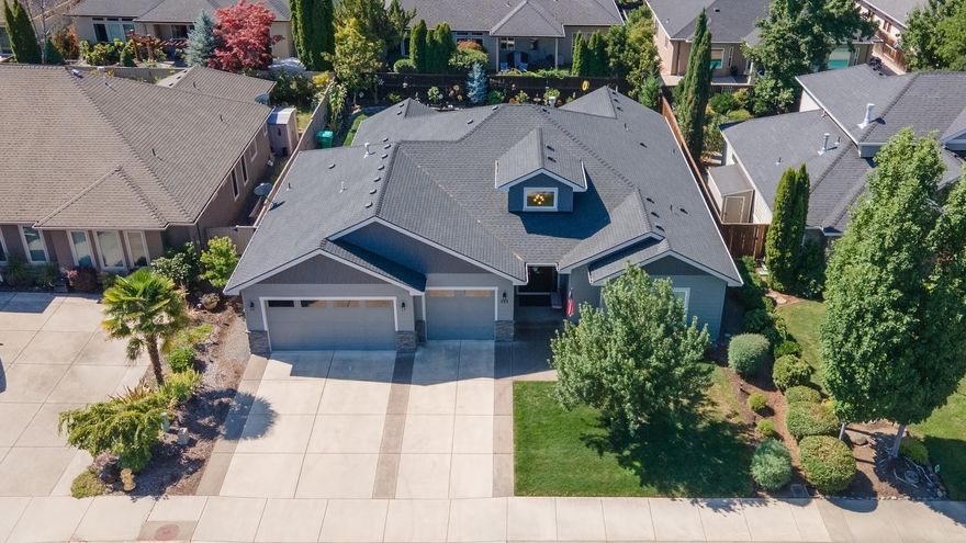 Live where you play at 988 Pumpkin Ridge in Eagle Point, Oregon! This beautifully maintained one-owner home, built in 2017, is move-in ready with an open, light-filled floor plan, quality finishes, and tasteful design throughout. The heart of the home is the living area with custom cabinetry surrounding the stone gas fireplace. The kitchen features quartz countertops, stainless steel appliances, under cabinet lighting, and an expansive island perfect for casual dining or entertaining. The spacious primary suite includes a walk-in closet and elegant en-suite bath, while guest rooms offer comfort and privacy. Enjoy relaxing evenings on the covered patio. Extra features include 10 foot ceilings and Levolor blinds throughout. Located in the desirable Eagle Point Golf Community, this home combines low-maintenance living with easy access to shopping, dining, and all the natural beauty Southern Oregon offers. This is the perfect opportunity to enjoy golf course living at its finest!