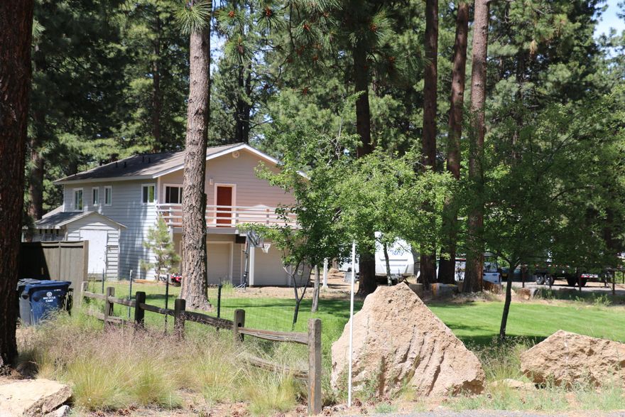 Room for all your toys on this canal frontage lot! With nearly 1/2 acre, you will find plenty of room on the outside and the inside of this home. Home is nearly fully remodeled, with new flooring, paint, kitchen cabinets, and countertops inside and a brand new deck outside. Downstairs features an open floor plan living, dining and kitchen with a new pellet stove, an oversized laundry/mudroom, one bedroom and a full bath.  Upstairs features 3 additional bedrooms plus a huge bonus room! Master bedroom has a walk in closet and its own private balcony. Exterior comes complete with canal frontage, mature trees, plenty of parking, all on a quiet street!