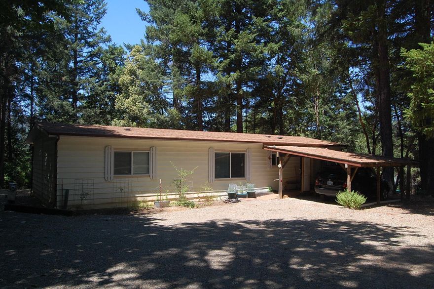 The seller will either go $265000 and seller pays $2500 toward buyer closing costs or price of $262,500 - either or....Really nice 2bedroom/2bath 1344sf 1980 double wide is located on .45 treed acres not far from town.  The roof was replaced in 2019, along with new blinds, vinyl windows, propane burning stove, ramp entrance and a new walk in shower with grab bars.  Storage shed/work shop, attached carport and a detached carport, room to park an RV. HAS tie downs also.
