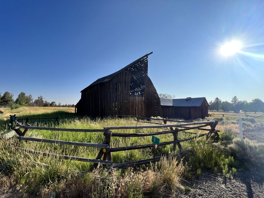 Irrigated acreage! Put your finishing touches on this home or build a replacement dwelling. The canal runs across the back side of this beautiful 16.31 acre property with 11 acres of COID irrigation (just seeded) Views of Mt. Jefferson. You will fall in love with the historic gambrel style barn up front as you turn down the private driveway to the set back house. Terrific property for raising 4-H animals.  The 40x60 barn has 4 birthing stalls and a center storage/tack room.  Very functional great room floor plan with a HUGE primary bedroom with walk in closet and ensuite bathroom.  2nd bedroom also has ensuite. Tons of storage rooms in both the home and the oversized detached 2 car garage with 2 workshops. New roof 2018, New septic drain field 9/2022, New well pump & plumbing lines, New carpet & flooring 2022. Most interior walls and ceilings have been painted in the last year. Front pasture is flood irrigated and back pasture is irrigated from the canal and back pond. Sold As-Is.