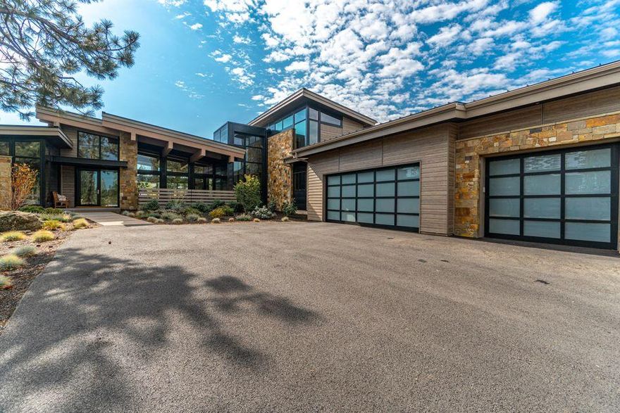 Stunning Tetherow Mountain-Modern residence inspired by Martis Camp architecture in Lake Tahoe. Designed by DesignHaus and built by Bend Trend Homes, attention to detail and quality exudes throughout. The expansive great room with unique 3 dimensional crossing beams immediately captures the essence of this distinctive property. Large metal-clad 3-panel sliding door system allows for a flowing indoor-outdoor living experience. Open kitchen & great room concept with large Statuario Milane quartz island surface. Wolf Range, dual dishwashers, built-in Wolf coffee/espresso machine, steam oven & microwave and Sub-Zero Fridge showcase the quality of appliances. This special property has it all...4 Bedrooms; 4 ½ Baths, Office, dining area with built-ins; 2 Bonus/
media rooms, front and rear outdoor patios, large 3-car garage with epoxy floor all situated on an almost ½ acre lot. Elegant master bathroom with soaking tub, large walk-in shower, and radiant heated floor.