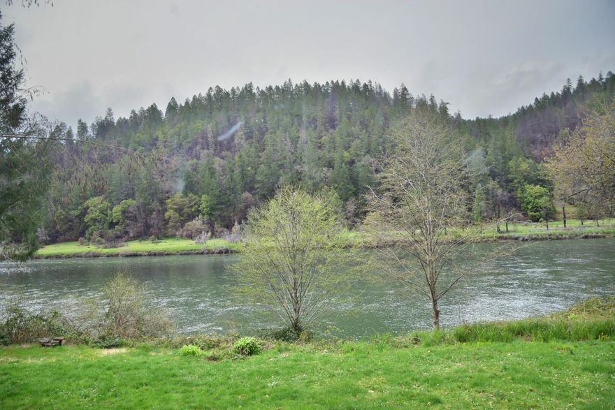 Back on no fault of property. Own a bit of History! The former 6 Bedroom, 6 Bath Rogue Glen Lodge. Your chance to return this Property to its former glory or convert to a resort or possible Airbnb! This once popular Fishing lodge sits upon the banks of the mighty Rogue River with 324 feet of river frontage and 1.21 acres in the Galice canyon just a stones throw from the Galice resort. The 5 bd rooms all have their own bathroom and the 6th has a dinette. The spacious living room has a stone fireplace and the entire interior still has the original wood lain flooring. There is a main kitchen that could be the cook area for a bed and breakfast business or possible church retreat.  Aux building has propane plumbed to it and has laundry hookups. The water source is spring fed. There are large maple trees for summer shade on the deck. Quiet river front evenings await you. This property is sold ''As-Is'' and is priced as such to allow for vision and opportunity. Call today this wont last long