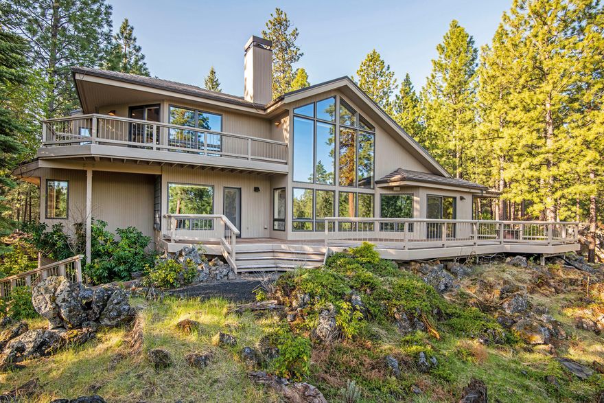 The ultimate entertainers home! Located on a peaceful private lot, fully landscaped with mountain views! Main level offers a custom kitchen with tons of storage and room for entertaining. Enjoy the views from the large deck just off the kitchen. Great room has a gorgeous wood-burning fireplace perfect for those cozy winter days. Jack and Jill on-suites on main level. Laundry room off of garage entrance. Office is a great flex space and can be used as an additional bedroom conveniently with full bath just across the hall. Master on upper level is very private with a cozy sitting area just before you enter and a private deck. Over-sized 2nd Master on upper level has it's own exterior entrance. Move right in and enjoy all that BBR has to offer! It's a great place to vacation, and an even better place to live!