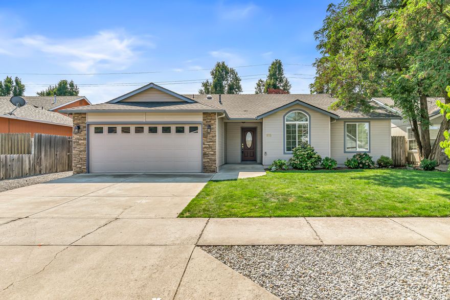 Well maintained & move-in ready, this 3BD/2BA home located in the desirable Hampton Place Estates is ready for your personal touches. Brand new roof installed this year with transferable roof warranty. Enter into a vaulted great room open to the dining & kitchen area complete with gas fireplace, solar tube & upgraded laminate flooring throughout. Kitchen features breakfast bar, matching white appliances & includes the refrigerator. Vaulted & spacious primary with slider door access to the covered back patio & bathroom with single vanity, neo angle shower & walk-in closet. Newer paint in guest rooms & second bathroom with large vanity & tub/shower combo. The backyard offers lush landscaping with raised garden beds, fruit trees & fenced area with chicken coop. Finished & oversized two car garage with epoxy floor & street parking available. Other upgrades include newer carpet in the bedrooms and exterior paint in the last 2 years. Great value with easy access to Rogue X & town amenities.