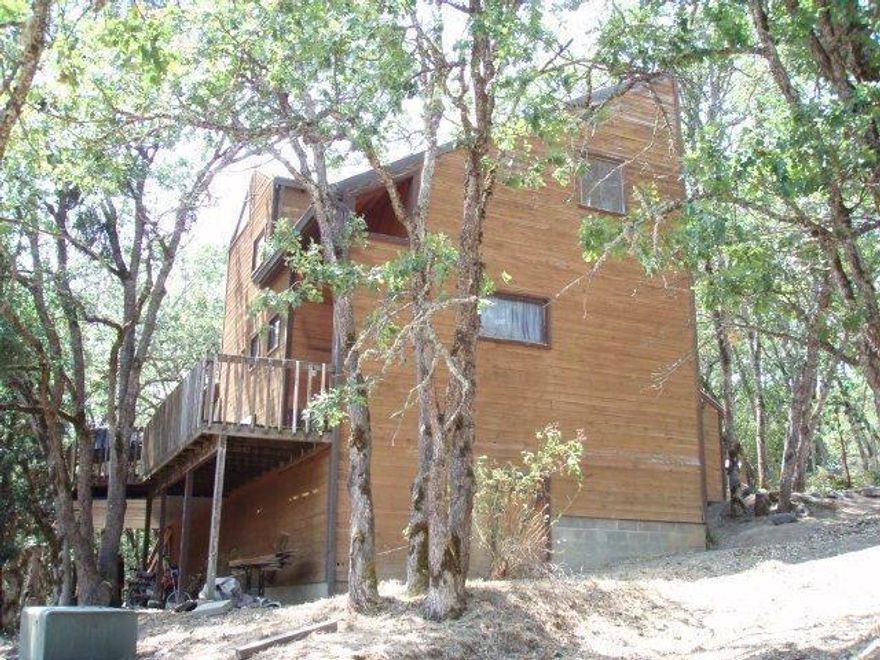 Wonderful setting among the trees on a little hill overlooking the property. Looking for privacy these homes have it. Two separate homes. Little one not permitted. Sale is as is where is. First home is 2201 sq ft. 3 bedrooms 2 bath, great elevated dining room and kitchen. In door laundry, master on ground floor, large decks in front and back part are covered. The second home is a very efficient 888 square ft, 1 bed, 1 bath with a 144 sq ft covered deck and a 292 sq ft deck in back. Indoor laundry and lots of storage. Pond is spring filled. Pontential to be developed. Buyer to do due diligence. To Irrigate with drip system per tenant.