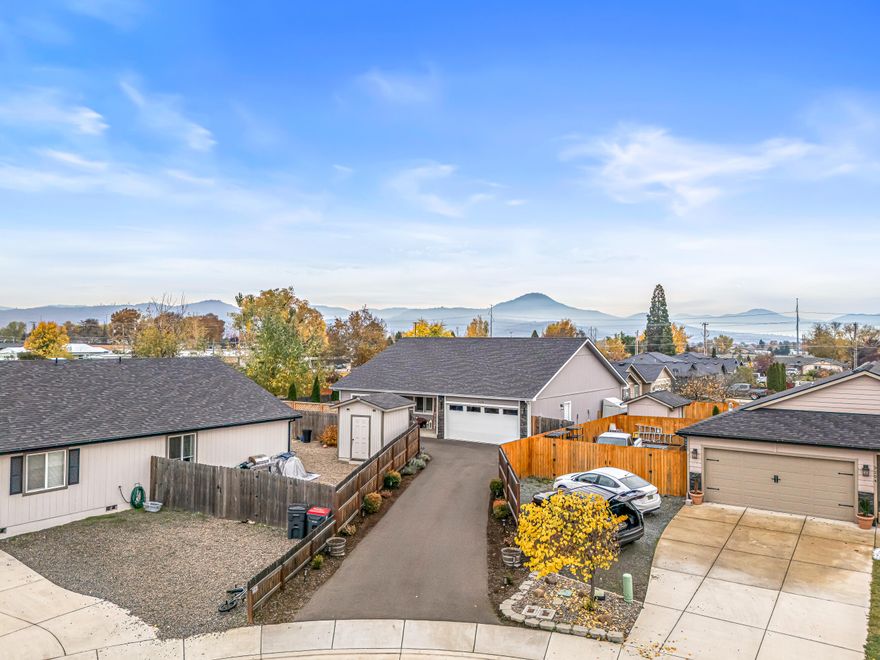 Ideally situated at the end of a quiet cul-de-sac, this modern single-level home—built in 2020 and still feeling brand new—blends comfort, quality, and thoughtful design. With 3 bedrooms, 2 bathrooms, and 1,580 sq ft of well-planned living space, it offers vaulted ceilings, abundant natural light, and clean, contemporary finishes throughout. The kitchen features beautiful custom cabinetry and a seamless flow into the dining and living areas—perfect for daily living or entertaining. Both bathrooms include double vanities and stylish fixtures. Custom blinds and shutters add a refined touch, while the backyard offers a private retreat with lattice fencing, mature fruit trees, and a flagstone patio ideal for relaxing or gatherings. Exceptionally well maintained, spotless, and move-in ready, this home combines modern convenience with low-maintenance living and timeless appeal.