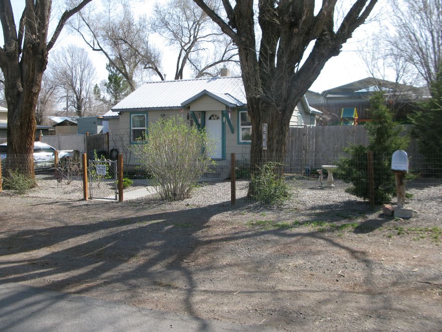 Cozy home with tons of charm and upgrades. New gas wall furnace, new ductless heater/air conditioner, Upgraded attic insulation and new appliances are just a few of the improvements that have been made to this charmer. New interior paint and laminate flooring make this home move in ready. The outdoor park like setting surrounding this home make the outside living space just as inviting as the inside. Flowers, ornamental bushes and grapes along with various trees are all well established around the property. Fenced backyard with storage shed and small greenhouse. There is even room to park the boat or RV. Call to see this place before its gone.