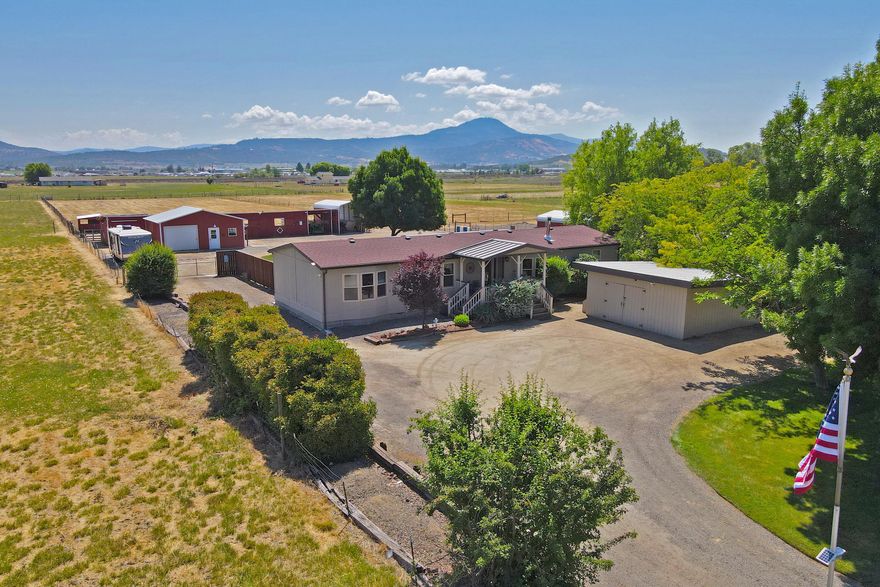 Charming 3 bed 2 bath manufactured home with QUALITY upgrades. Prime location, fully functional 5 acre mini farm on a dead-end lane. Enjoy a peaceful rural lifestyle with convenient access to amenities. Numerous outbuildings provide ample space for living, raising animals and plenty of storage. Ideal hobby farm or property for an aspiring homesteader. Beautifully landscaped, fully fenced and cross fenced. This property was laid out with thought and purpose. Water from a strong producing well (per seller) and electrical infrastructure is conveniently spread throughout the property, maximizing usability and convenience. Significant upgrades and improvements; please refer to the attached documents for a detailed list. Embrace a self-sustainable lifestyle without the big commute to town!