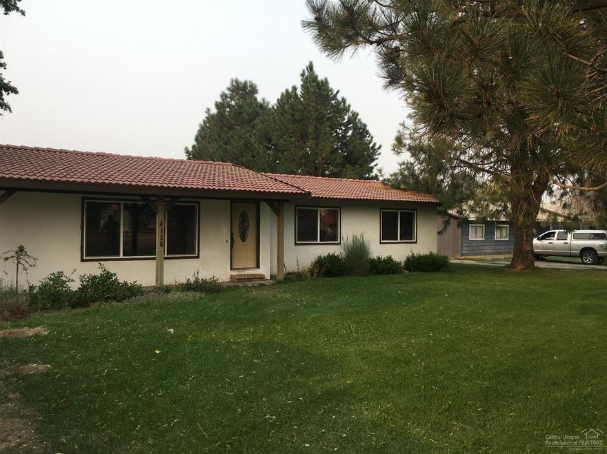 Desirable horse property! Cute ranch home on 1.15 acres. Fenced yard & fenced, irrigated pasture with two stall barn. Recent updates include new flooring, kitchen cabinetry and counter tops, and new tile, counters and floors in the bathrooms. Additional office could easily be converted back into third bedroom. Lots of space to park horse trailers, RV, etc. New Price!