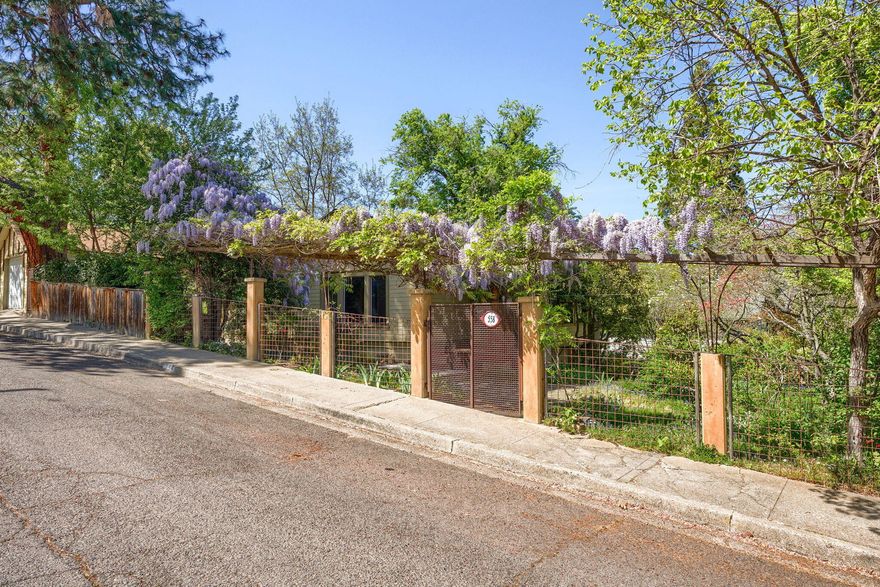 Lovingly detailed craftsman bungalow in Ashland's historic district with income or dual-family opportunities. Upstairs two-bedroom one-bath home, and downstairs one-bedroom apartment. Light and airy upstairs. Versatile entry area with a sun room feel. Living room with bay windows and great light. Dining area or additional living space with beautiful built-ins and leaded glass giving so much character. Hardwood floor in dining and kitchen. Updated kitchen with custom cabinetry, granite countertops, large island, and ample storage. Spacious primary bedroom. Tiled bath with clawfoot tub. Shaded deck off of kitchen overlooking the yard, perfect for enjoying the view of the hills. Cozy downstairs apartment. Open kitchen and living area with additional built-in details and breakfast bar. Finished detached garage is great for shop or studio space. Lush yard with mature wisteria and plantings.