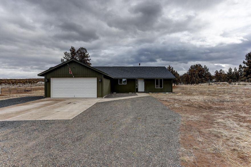 Enjoy the peace and quiet in this fantastic, single level home on nearly two acres. Just 20 minutes to Prineville Reservoir and super close to BLM land where you can hike for miles, ride bikes, or enjoy a nice long walk with your four-legged friend. This home offers a large, open concept floorplan, and has wonderful separation of the bedrooms. Large kitchen Island is perfect for entertaining family and friends. The living room features vaulted ceilings for that airy feel, a sliding glass door leading out to the massive backyard where you can cozy up around the outdoor firepit, and a wood stove for those cold winter nights. The possibilities are endless, build a shop, barn, bring some animals, and enjoy more than enough space to store all your toys.