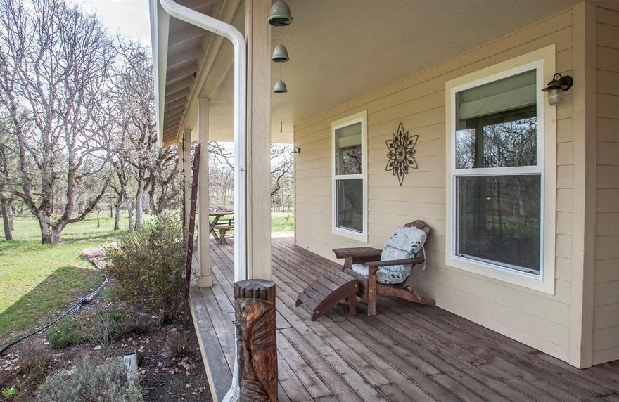 Looking for a beautiful secluded country home with energy-efficiency? Here it is! From the moment you pass through the security gate, you'll know you are someplace special. Tucked away in the center of this lovely treed 5+ acre parcel, enjoy peaceful views from the wrap-around deck, open-concept interior or wandering the property. Light & open with big windows & solar tubes. 9' ceilings in non-vaulted rooms. Oriented to make efficient use of the sun. Woodstove keeps the home toasty warm in the winter. Great room with slate floor & charming kitchen with maple cabinets, tile countertops & S/S appliances. Corner master suite (16'x14') with exterior access. Bedrooms have bamboo flooring & walk-in closets. Guest bedroom is 11'x14. Bonus room (11.5'x11.5') works great for home-office or 3rd bedroom. Shed (17'x9') + storage overhang. Solar panels (pole mounted/on grid)--elec bills currently avg $20/mo. Solar water heater + conv unit--hybrid or solo either unit. Cement fiber board lap siding.