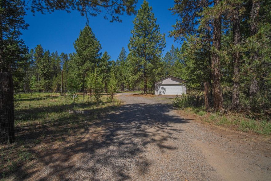 Corner lot with a 2 car garage. Level building site. New well in 2022 - see attached docs. Septic on property. Singlewide manufactured home was removed 6/2025. Located off the paved 6th Street on the SW end of La Pine. Make this your new home site or basecamp! Garage has metal roof.  The driveway is on the Cedar Rd side. Fenced on the south and west sides of the property. Septic report and water quality completed July 2025.